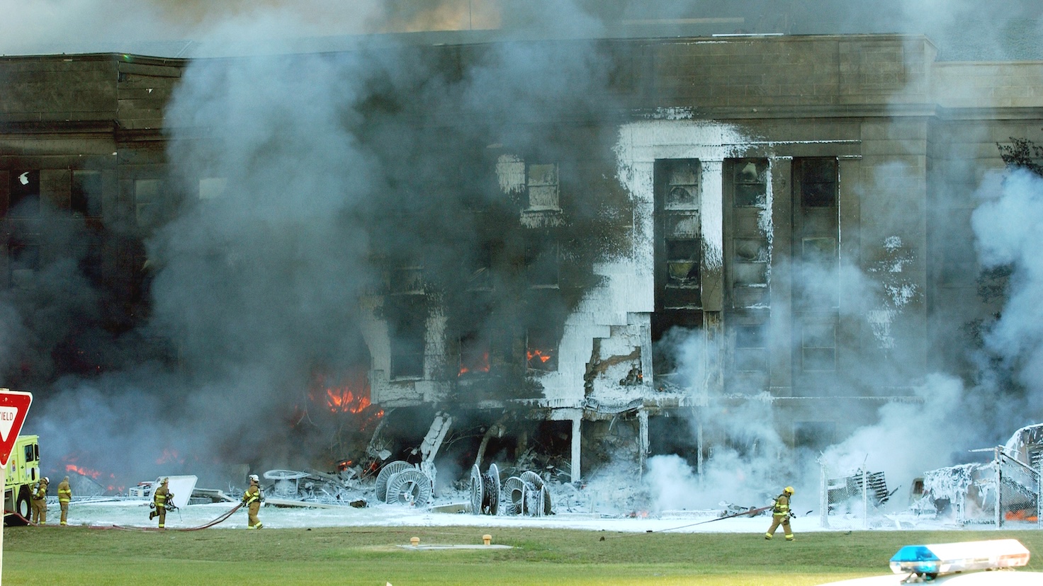 Firefighters work to put out the flames moments after a hijacked jetliner crashed into the Pentagon at approximately 0930 on September 11, 2001.